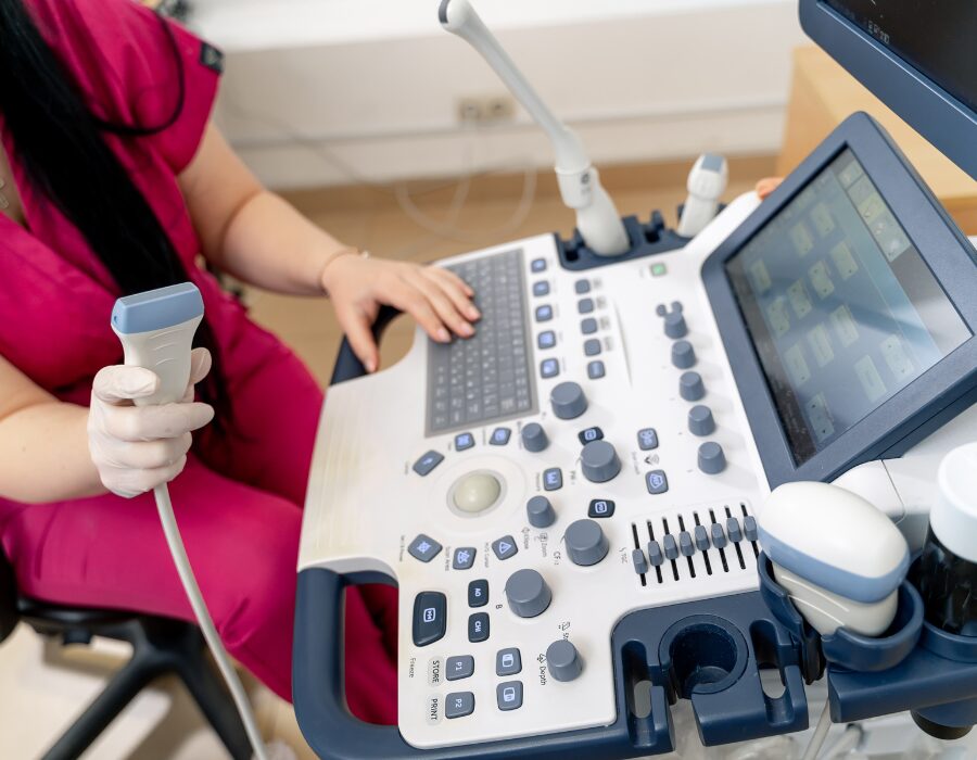 Medical technician using ultrasound equipment.
