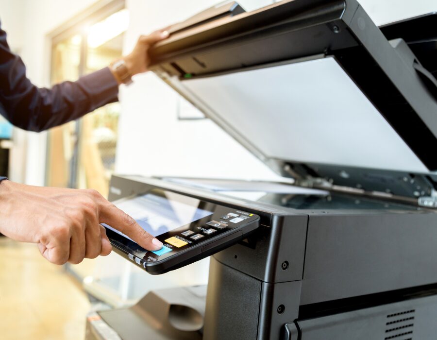 Person using a multifunction printer.