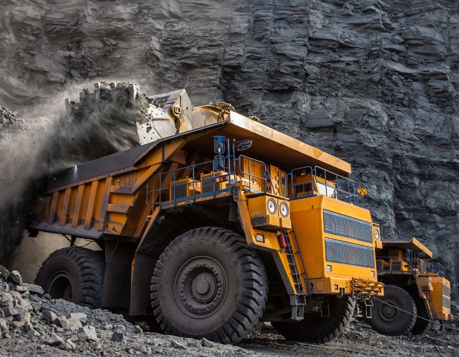 Large mining dump truck unloading rocks