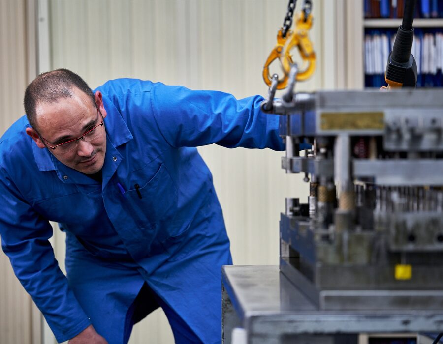 Engineer inspecting a heavy industrial machine component.