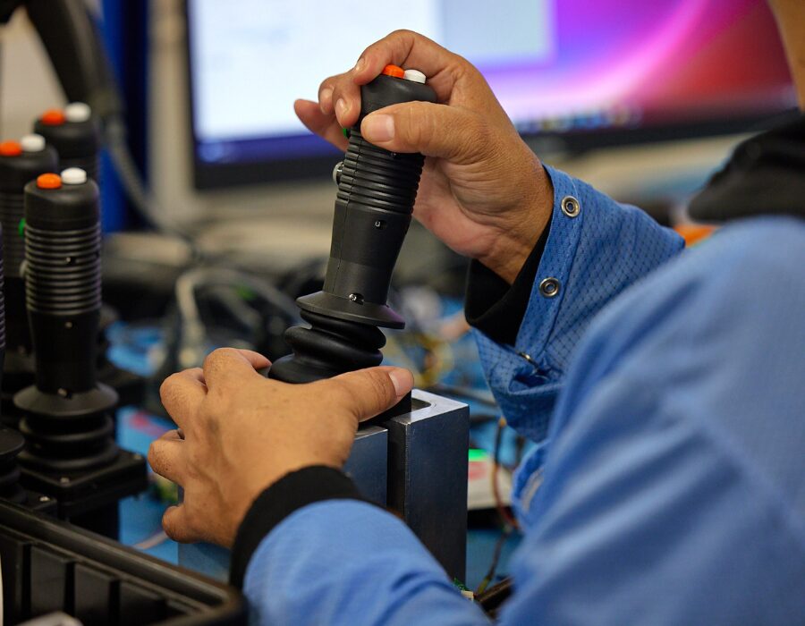 Technician manipulating a joystick.