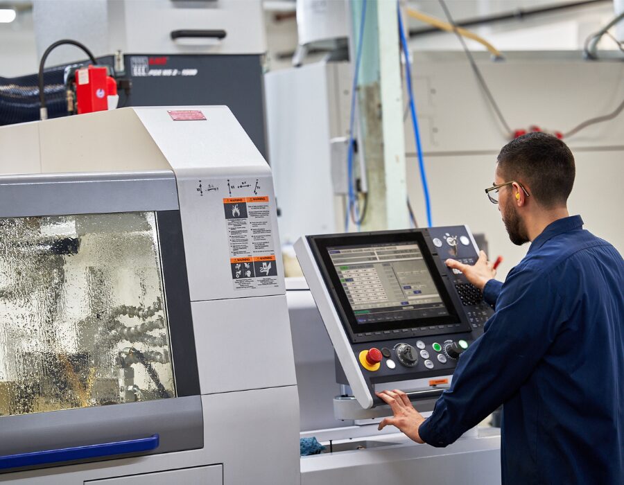 Operator using a touchscreen control panel for machine.