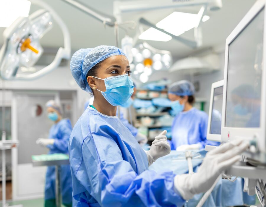 Surgeon using a touchscreen monitor in an operating room.